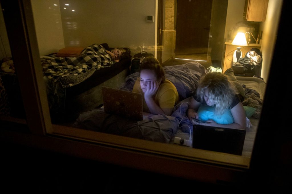 Third Place, Feature Picture Story - Jessica Phelps / Newark Advocate, “Nurses Go On Lockdown With Residents”Marissa Taggart , Keyerra Cochran and Sarah Stephens all nurses and aides at The Inn at Chapel Grove lay on their beds in the assisted senior living residence after finishing their shift March 22, 2020. They and their colleagues have all decided to voluntarily lock themselves in with the residents to further protect them from the coronavirus. No one is currently entering or leaving Heath's Chapel Grove or its sister facility in Newark, SharonBrooke where staff have voluntarily shut themselves in for the well being of the residents.